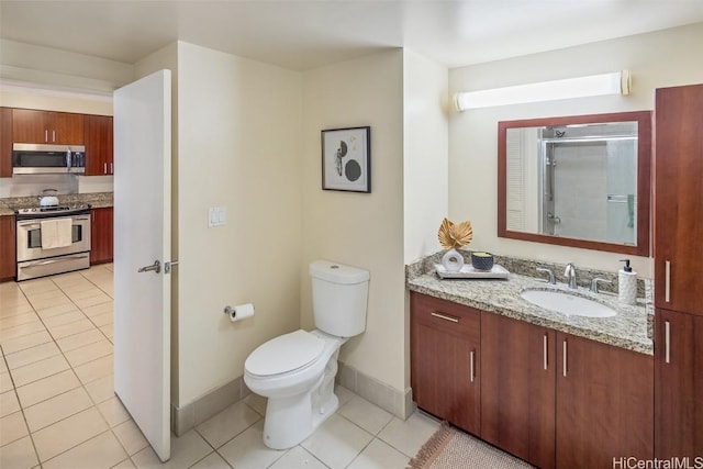 full bath with baseboards, toilet, vanity, a stall shower, and tile patterned flooring