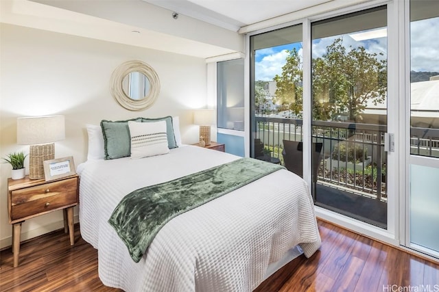 bedroom with access to exterior, expansive windows, and dark wood-type flooring