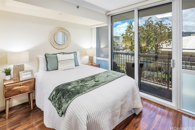 bedroom featuring floor to ceiling windows, wood finished floors, and access to outside