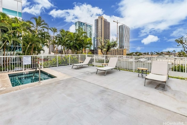 view of pool with a patio and a hot tub