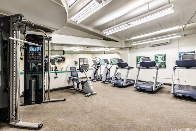 gym featuring a wall mounted AC and carpet