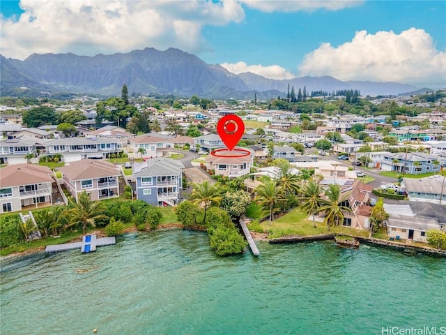 drone / aerial view featuring a water and mountain view