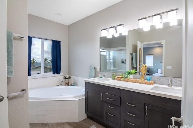 bathroom featuring hardwood / wood-style flooring, vanity, and independent shower and bath