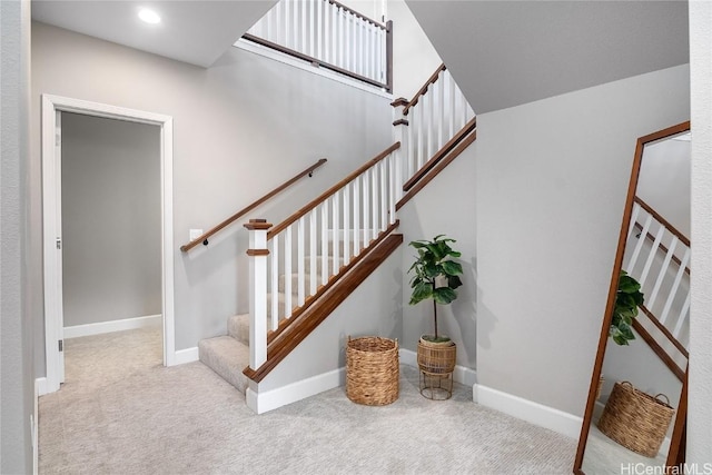 staircase featuring carpet, baseboards, and recessed lighting