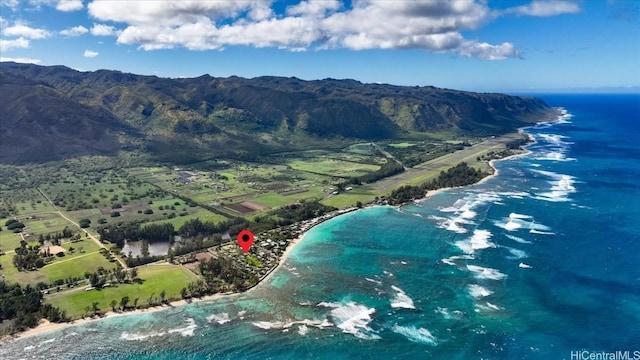 drone / aerial view with a water and mountain view