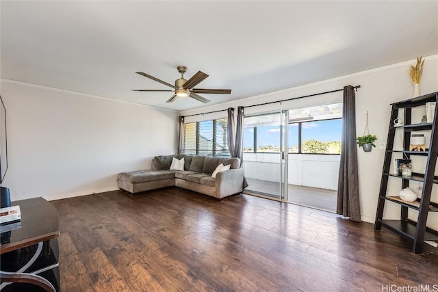 living area with baseboards, ceiling fan, ornamental molding, and wood finished floors