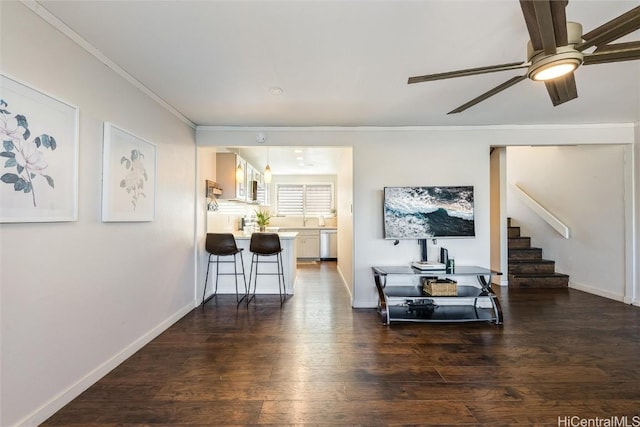 living room with ceiling fan, dark wood-type flooring, and crown molding