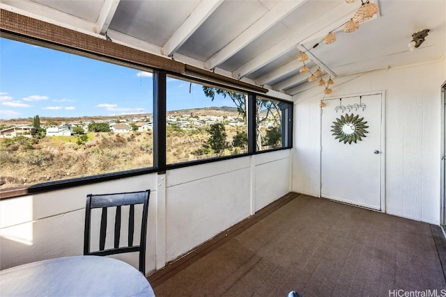 unfurnished sunroom with lofted ceiling