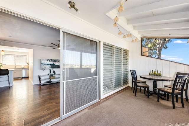 dining space with ceiling fan, a wealth of natural light, and beamed ceiling