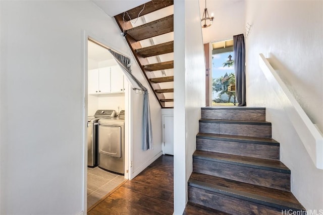 stairs featuring hardwood / wood-style floors, beam ceiling, and washing machine and dryer