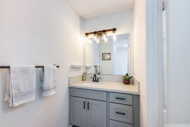 bathroom with vanity and a textured ceiling