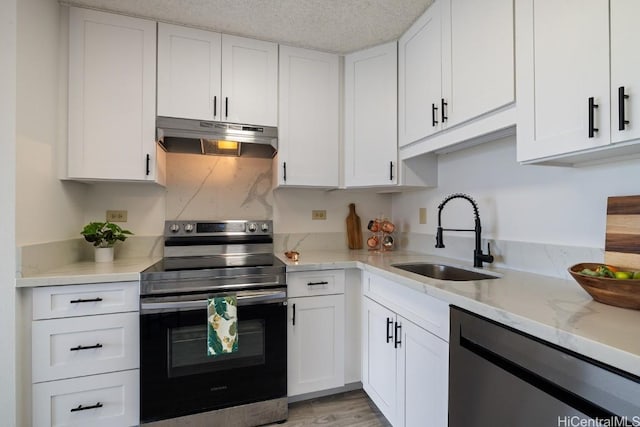 kitchen featuring light stone countertops, white cabinetry, sink, and stainless steel appliances