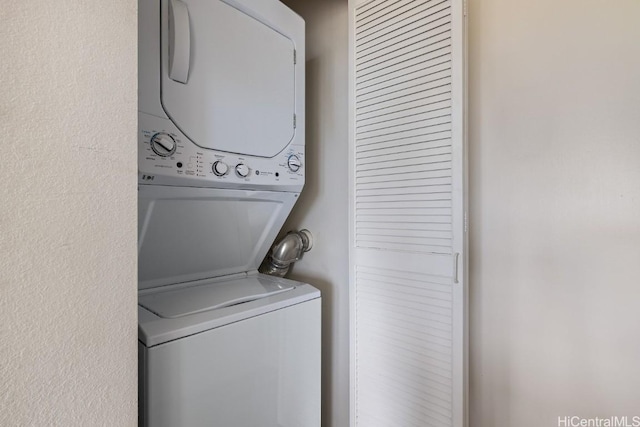 laundry room with stacked washing maching and dryer