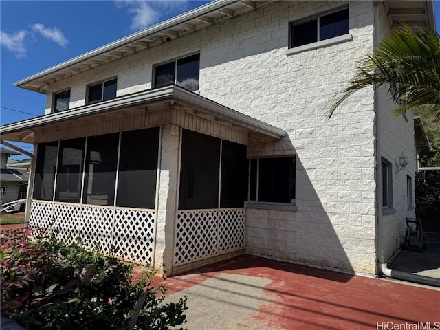 view of side of home featuring a sunroom