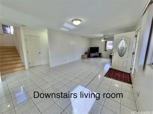 entryway featuring ceiling fan and light tile patterned flooring