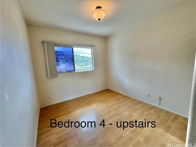 empty room with hardwood / wood-style floors