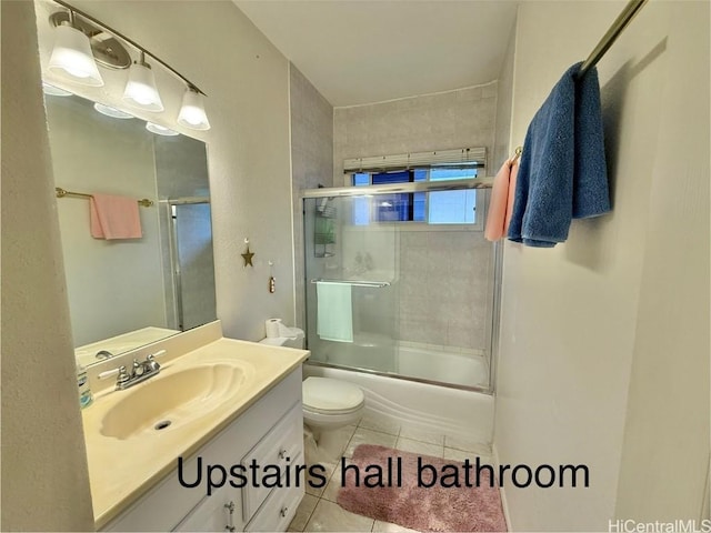 full bathroom featuring tile patterned floors, vanity, bath / shower combo with glass door, and toilet