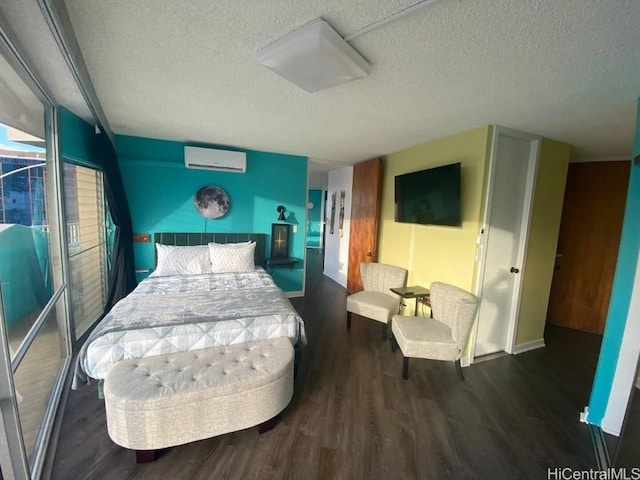 bedroom with an AC wall unit, dark hardwood / wood-style floors, and a textured ceiling