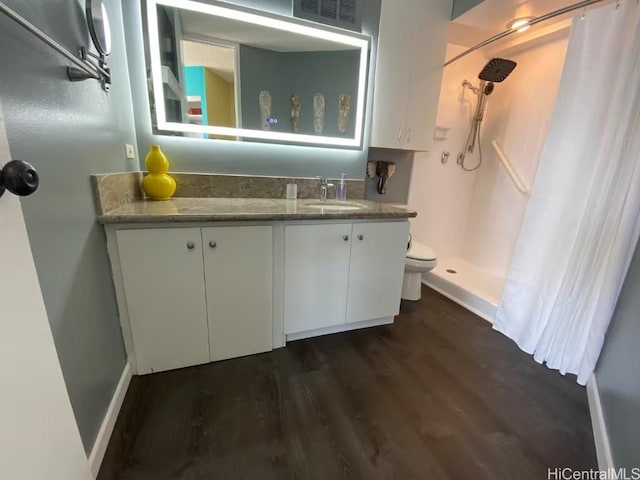 bathroom featuring a shower with shower curtain, vanity, and hardwood / wood-style flooring