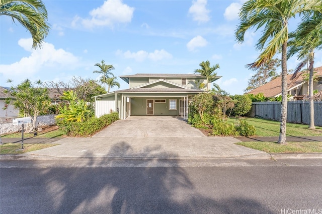 view of front of property with a front lawn and a carport