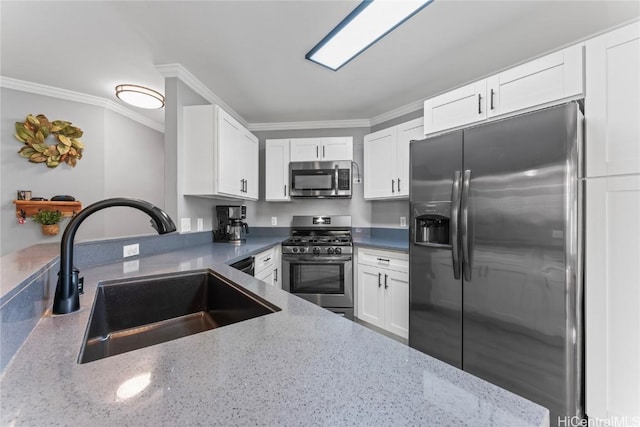 kitchen with crown molding, appliances with stainless steel finishes, white cabinetry, sink, and light stone counters