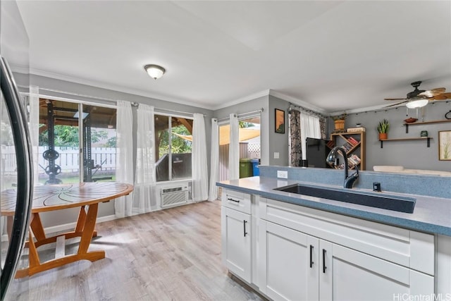 kitchen with sink, white cabinets, a healthy amount of sunlight, and ceiling fan