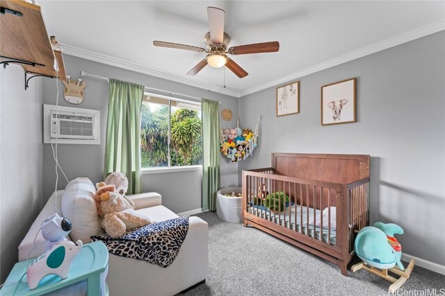 bedroom featuring a nursery area, carpet, ornamental molding, ceiling fan, and a wall mounted AC