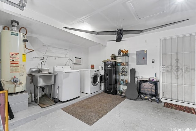 laundry room with sink, gas water heater, electric panel, and washing machine and clothes dryer