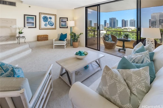 living room with floor to ceiling windows and light colored carpet