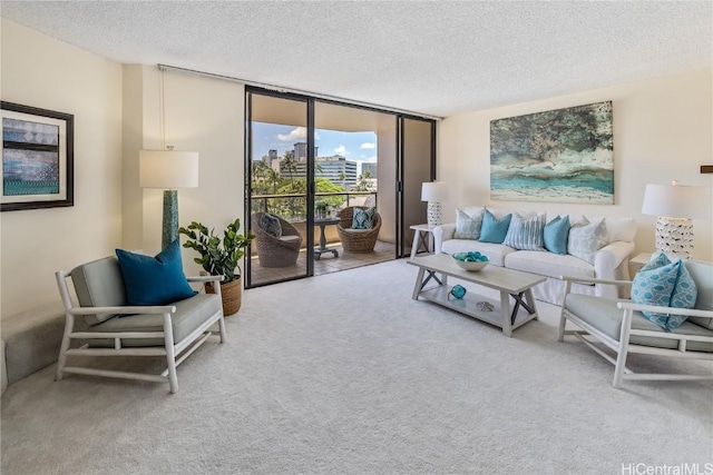 living room with a textured ceiling, carpet floors, and floor to ceiling windows