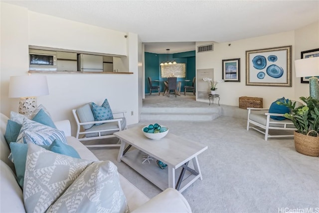 living room with light carpet and an inviting chandelier