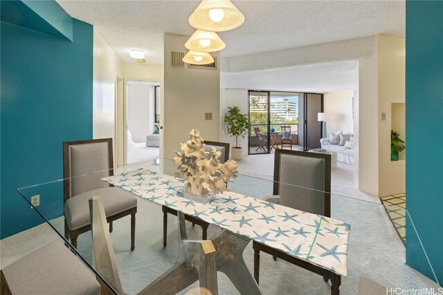 dining space featuring a textured ceiling