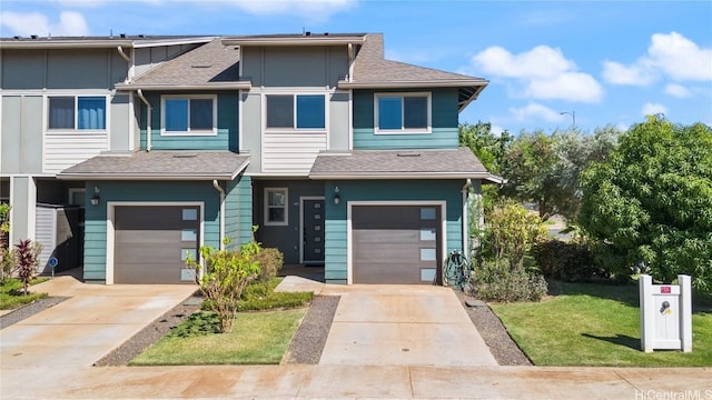 multi unit property featuring a garage and a front yard