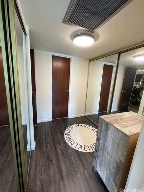 hallway featuring dark hardwood / wood-style flooring