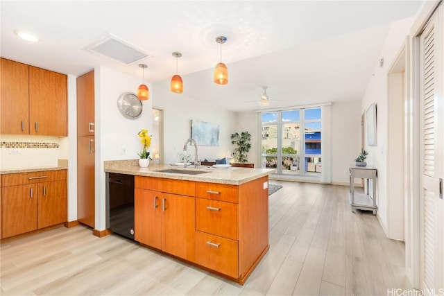 kitchen with sink, ceiling fan, black dishwasher, decorative light fixtures, and kitchen peninsula