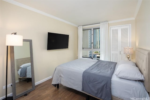 bedroom featuring dark hardwood / wood-style floors, ornamental molding, and a closet