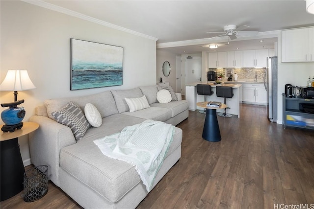 living room featuring crown molding, ceiling fan, and dark wood-type flooring