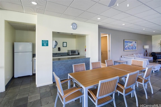 dining area featuring a paneled ceiling and sink