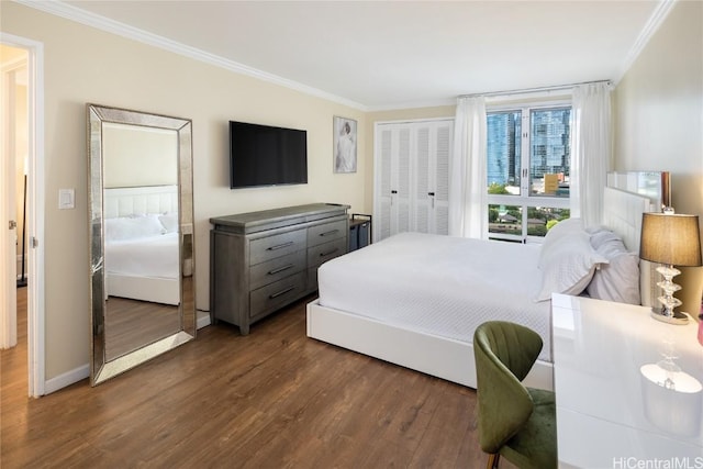 bedroom with dark hardwood / wood-style flooring, a closet, and ornamental molding