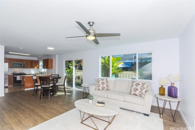 living room featuring light hardwood / wood-style floors and ceiling fan