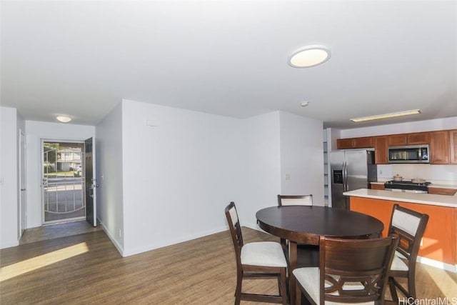 dining space with dark hardwood / wood-style floors