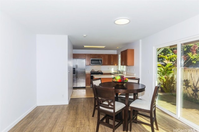 dining room with sink and hardwood / wood-style floors