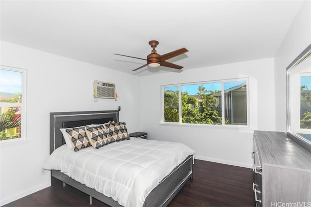 bedroom with ceiling fan, dark hardwood / wood-style floors, and a wall mounted AC