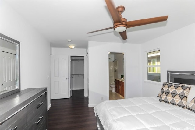 bedroom with ensuite bath, dark wood-type flooring, a closet, and ceiling fan