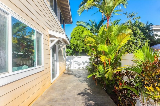 view of property exterior with a patio area