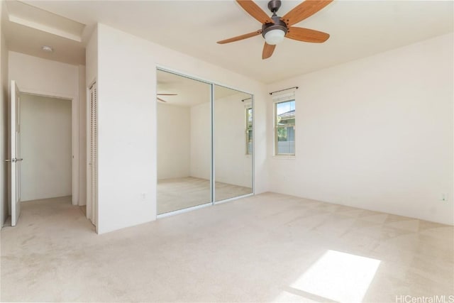 unfurnished bedroom with light carpet and ceiling fan