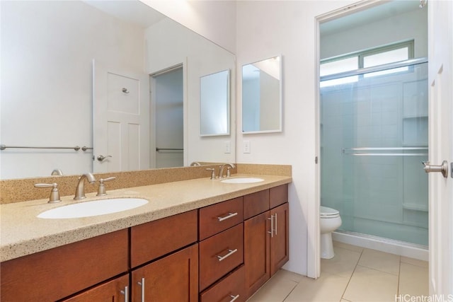 bathroom with tile patterned floors, vanity, an enclosed shower, and toilet