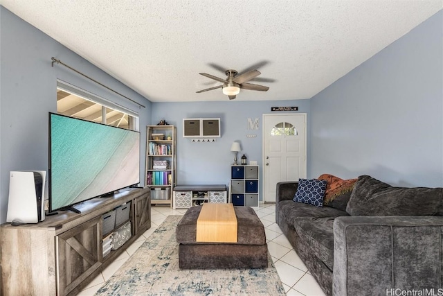 tiled living room with ceiling fan and a textured ceiling