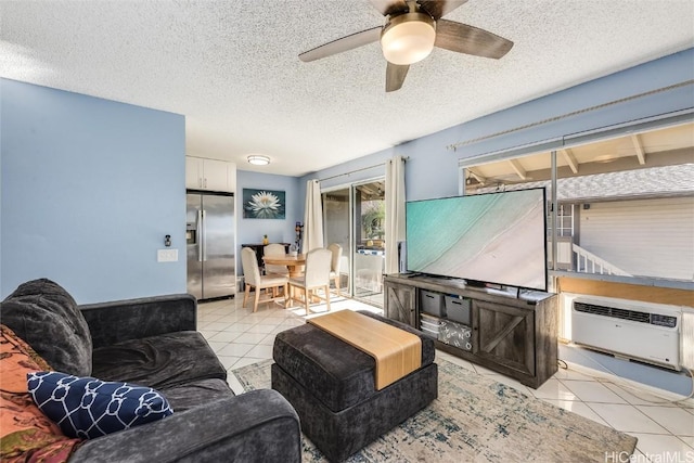 living room featuring a wall unit AC, a ceiling fan, a textured ceiling, and light tile patterned flooring