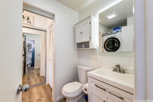 bathroom with vanity, toilet, and wood finished floors